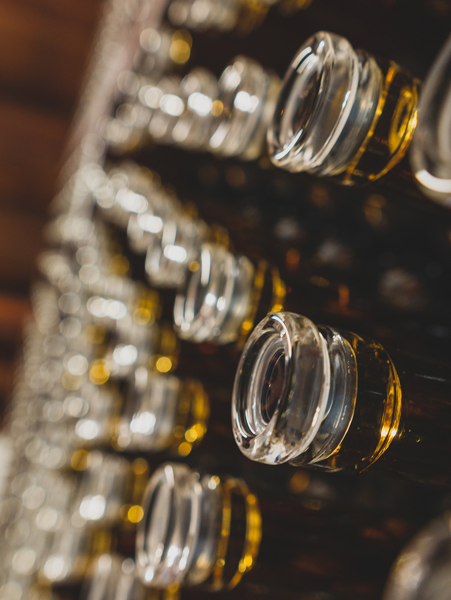 Commandaria bottles stacked in the Revecca Winery cellar