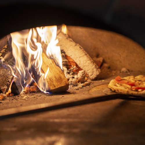 baking-delicious-pizza-with-wood-fired-oven